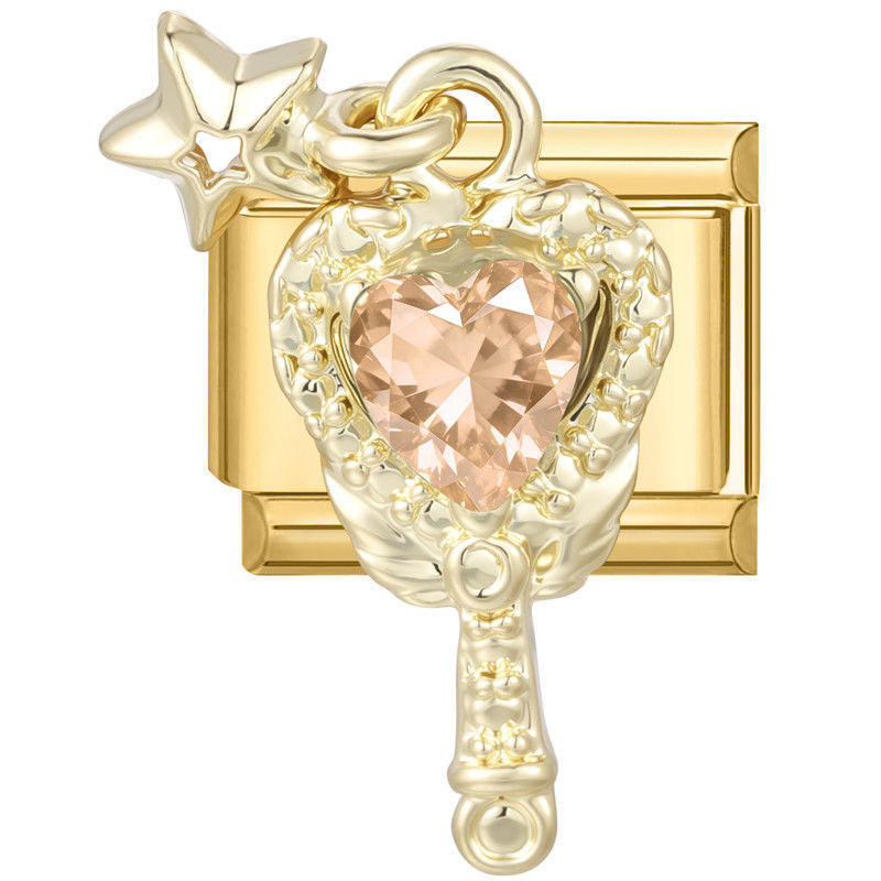 Espejo de mano dorado con piedra rosa en forma de corazón y estrella